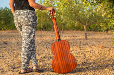 Low section of woman standing on ground
