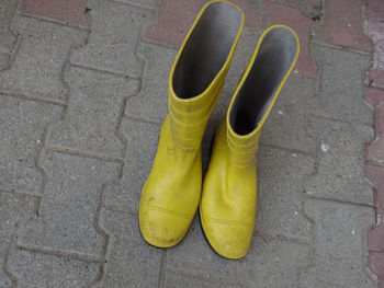 High angle view of shoes on footpath