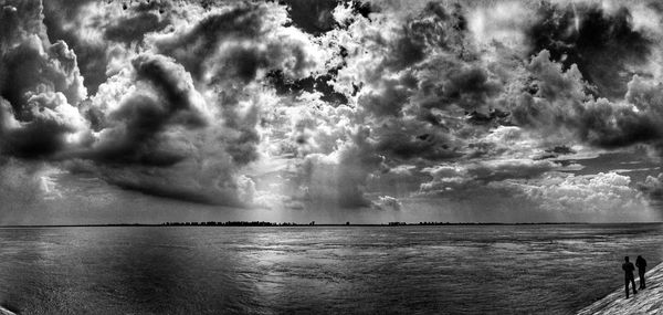 Scenic view of sea against storm clouds