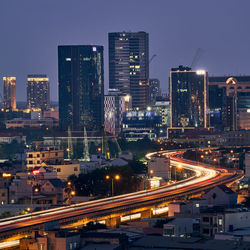 High angle view of illuminated city street and buildings at night