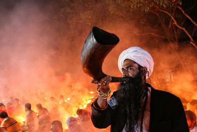 A saint blowing buffalo horn in rakher upobash at barodi lokhnath brahmachari ashram