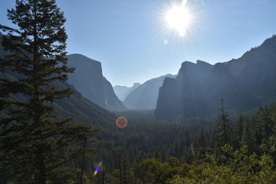 Scenic view of mountains against bright sun