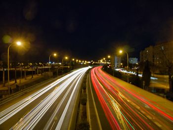 High angle view of light trails on highway at night