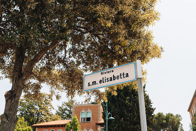 Low angle view of road sign against sky