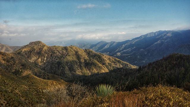 mountain, mountain range, tranquil scene, tranquility, scenics, sky, landscape, beauty in nature, nature, non-urban scene, cloud - sky, cloud, idyllic, remote, grass, outdoors, no people, day, physical geography, non urban scene