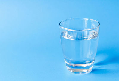 Close-up of drink in glass against blue background