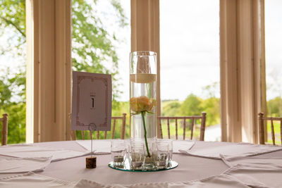 Empty chairs and table against window at home