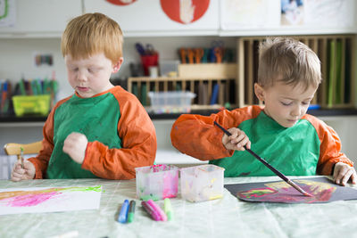 Two boys painting