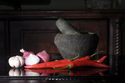 Close-up of red chili peppers on table