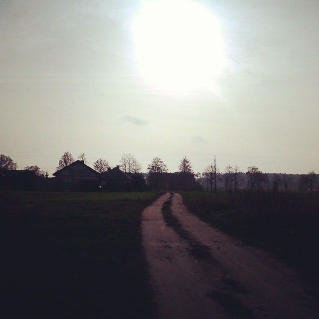 building exterior, architecture, built structure, the way forward, sky, road, diminishing perspective, sunlight, vanishing point, sun, field, street, transportation, house, outdoors, sunbeam, empty, day, no people, nature