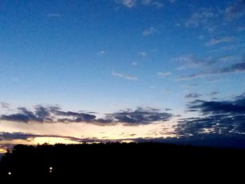 Low angle view of silhouette landscape against sky during sunset