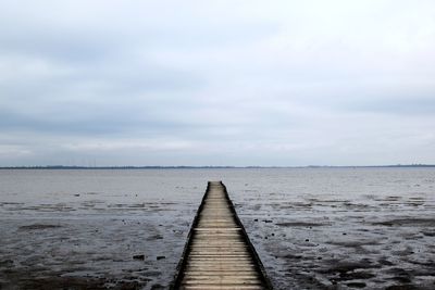 Pier over sea against sky