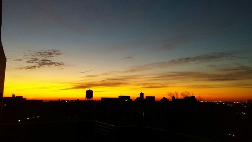 Silhouette of cityscape at sunset