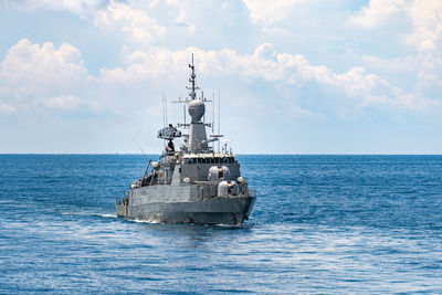 Ship sailing in sea against sky