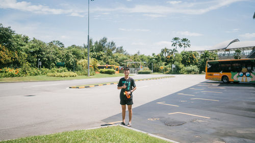 Rear view of woman walking on road