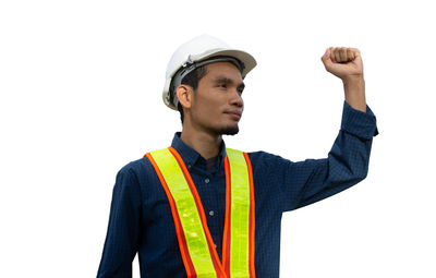 Young man looking away against white background