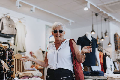 Senior woman in clothes shop