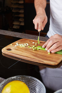 Midsection of man preparing food on table