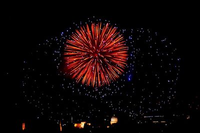 Low angle view of firework display at night