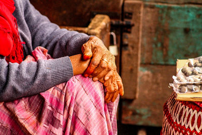 Midsection of woman with hands clasped