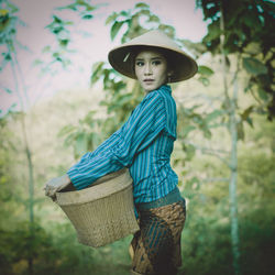 Portrait of man wearing hat standing in basket