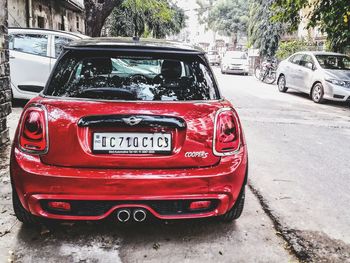 Close-up of red car on street