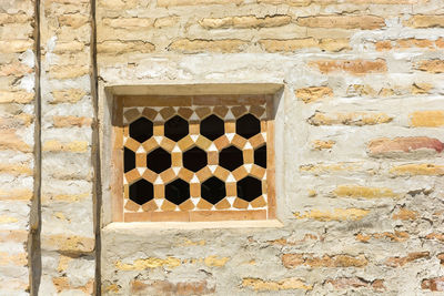 Close-up of window on brick wall