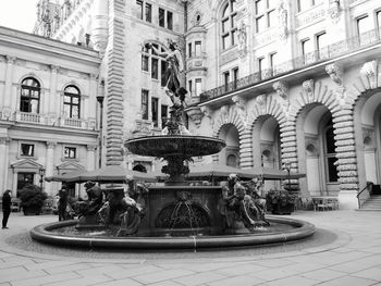Fountain against building in city