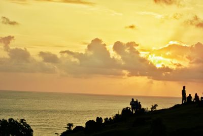 Silhouette of people on beach during sunset