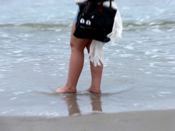 Woman standing on shore