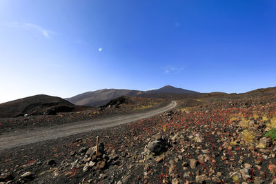 Scenic view of mountains against clear blue sky