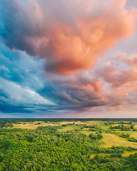 Scenic view of field against cloudy sky