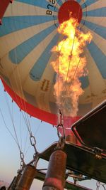Low angle view of woman holding hot air balloon