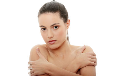 Portrait of shirtless young woman against white background