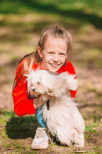 Cute girl with dog on field