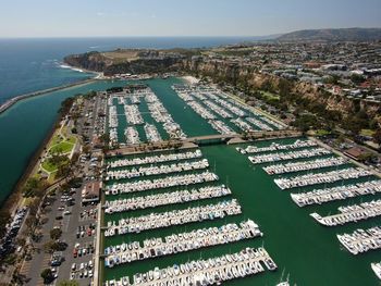 High angle view of buildings by sea against sky