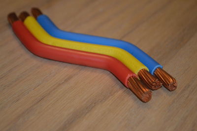 Close-up of colorful cables on wooden table