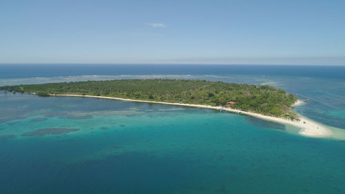 Tropical island with white sandy beach. aerial view of magalawa island with colorful reef. 