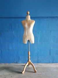 Mannequin against blue wall