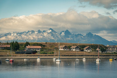 Scenic view of lake by mountains against sky