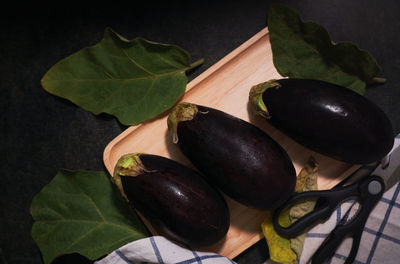 High angle view of fruits and leaves on table