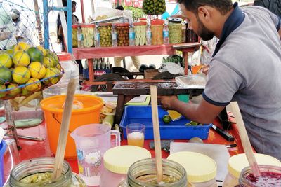 Side view of a man holding food at market