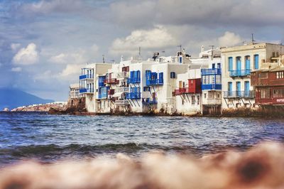 Panoramic view of sea against buildings