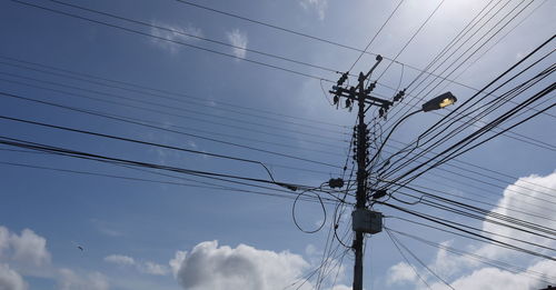 Low angle view of electricity pylon against sky