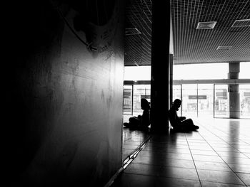 Silhouette people walking in airport building