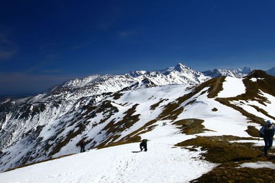 Scenic view of snowcapped mountain against blue sky