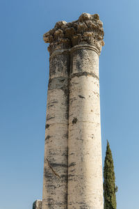 Low angle view of old ruin against blue sky