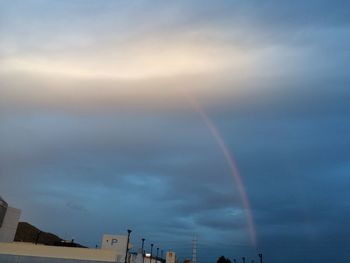 Low angle view of rainbow over buildings in city