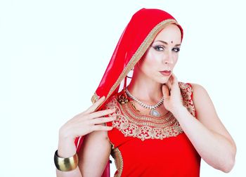 Portrait of beautiful young woman against white background