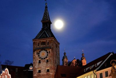 Low angle view of bell tower against blue sky